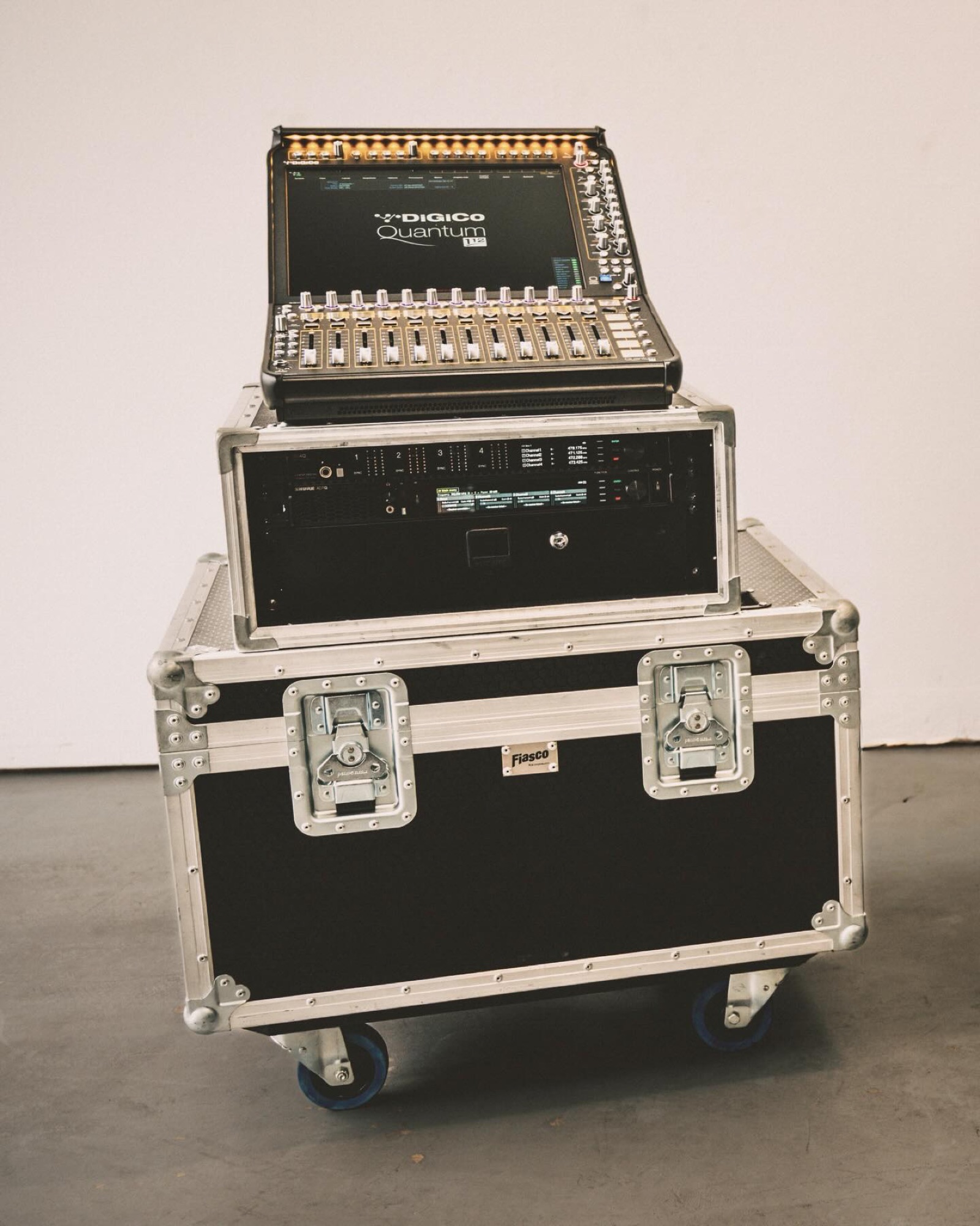 A compact DiGiCo Quantum console staged on a flight case against a clean white background.