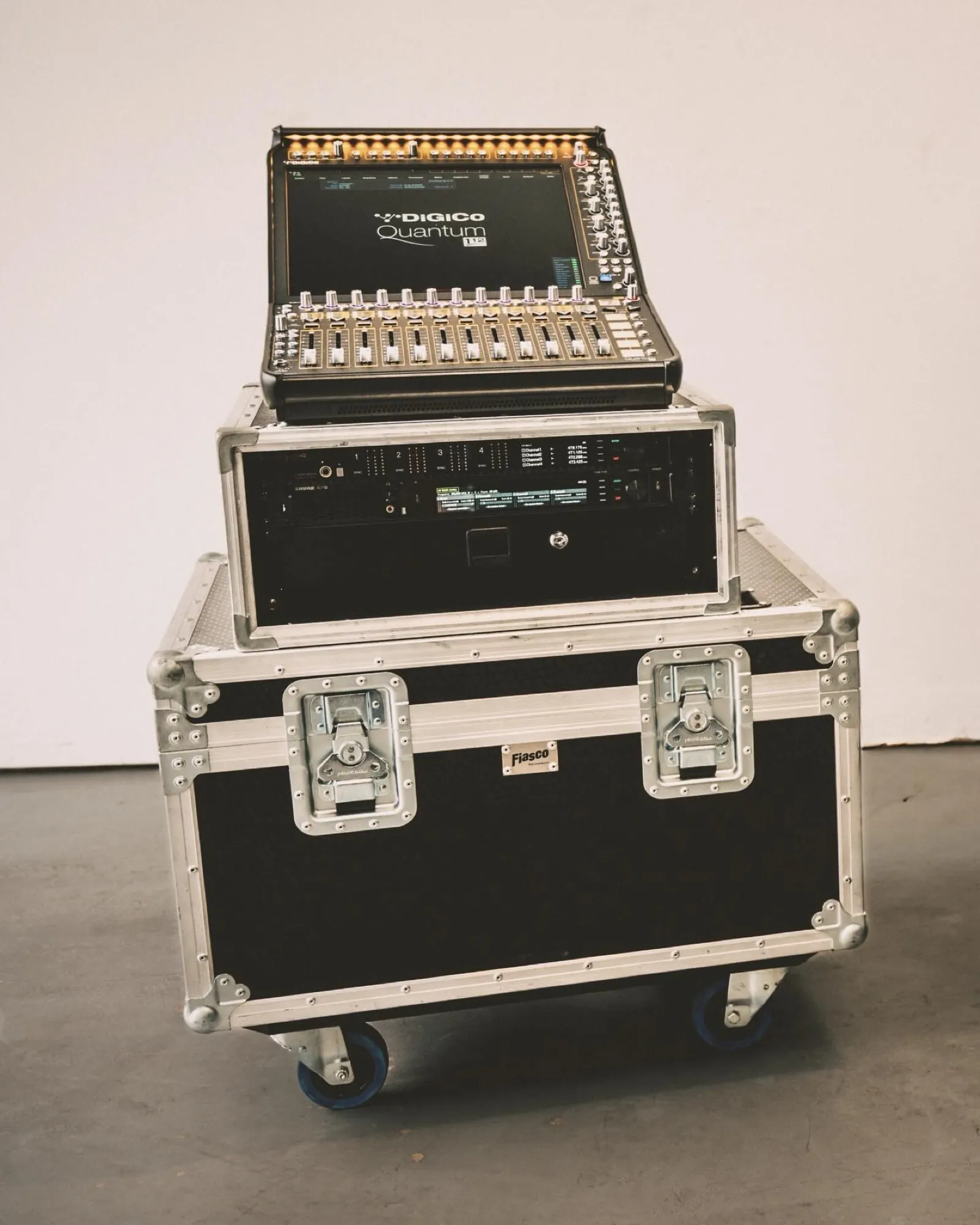 A compact DiGiCo Quantum console staged on a flight case against a clean white background.